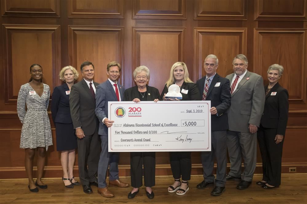 Officials accepting grant with Governor Kay Ivey for Myrtlewood Elementary. Officials accepting grant with Governor Kay Ivey for Myrtlewood Elementary.